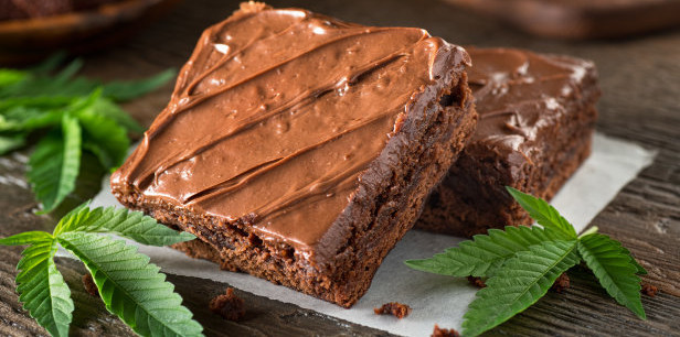 Homemade pot brownies with marijuana leaf garnish
